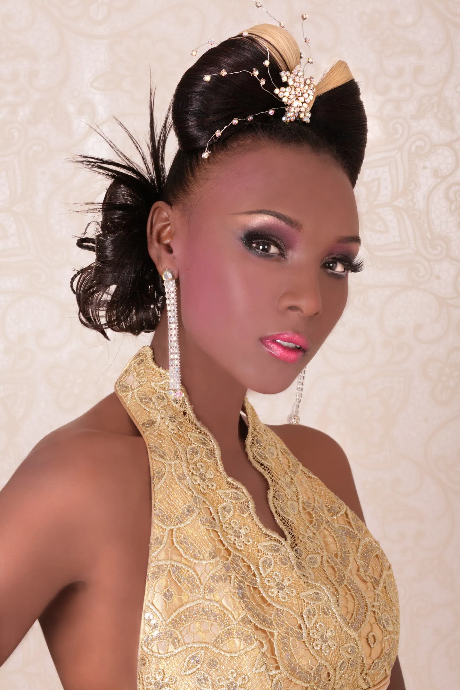 Bride with a sculpted bow updo and a jewelled star pin, in a gold lace halter