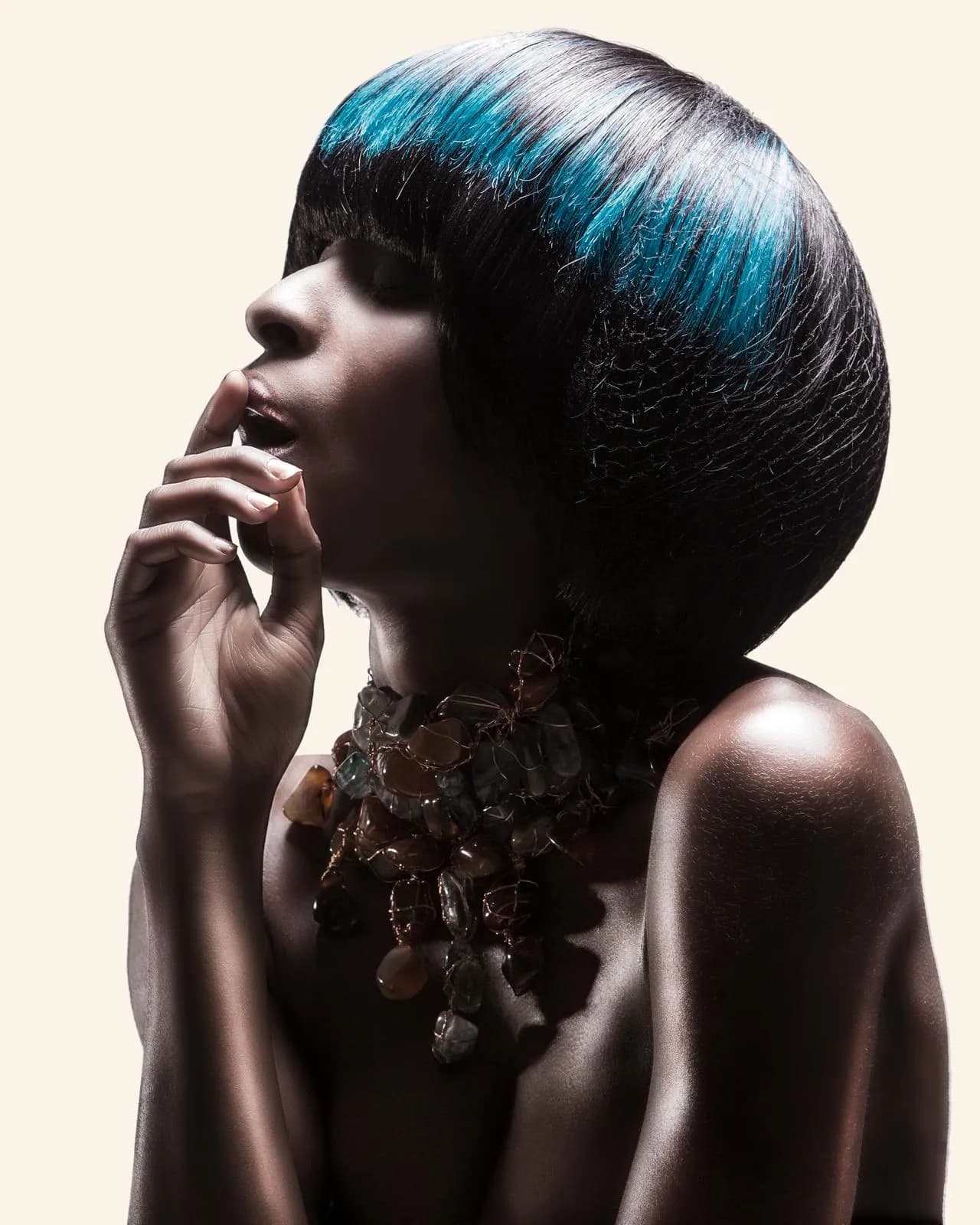 Profile of a sleek, glossy bob with a blue panel through the crown