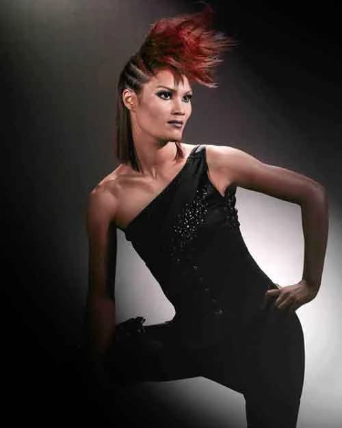Red spiked mohawk with braided sides, with a black one-shoulder jumpsuit