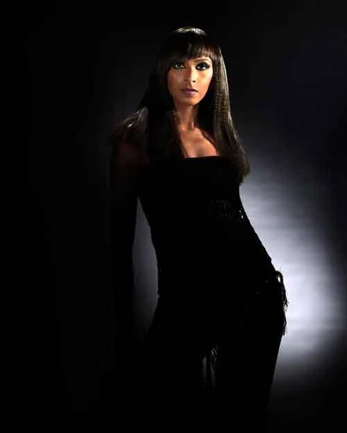 Long, sleek straight hair with a full fringe, with a black dress
