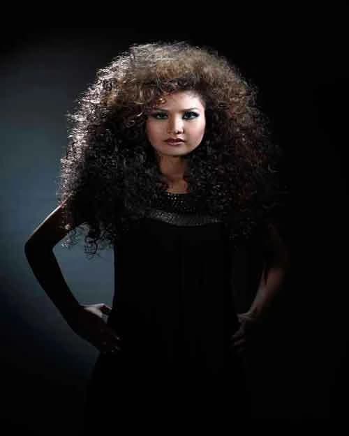 Long, voluminous spiral curls with a black dress