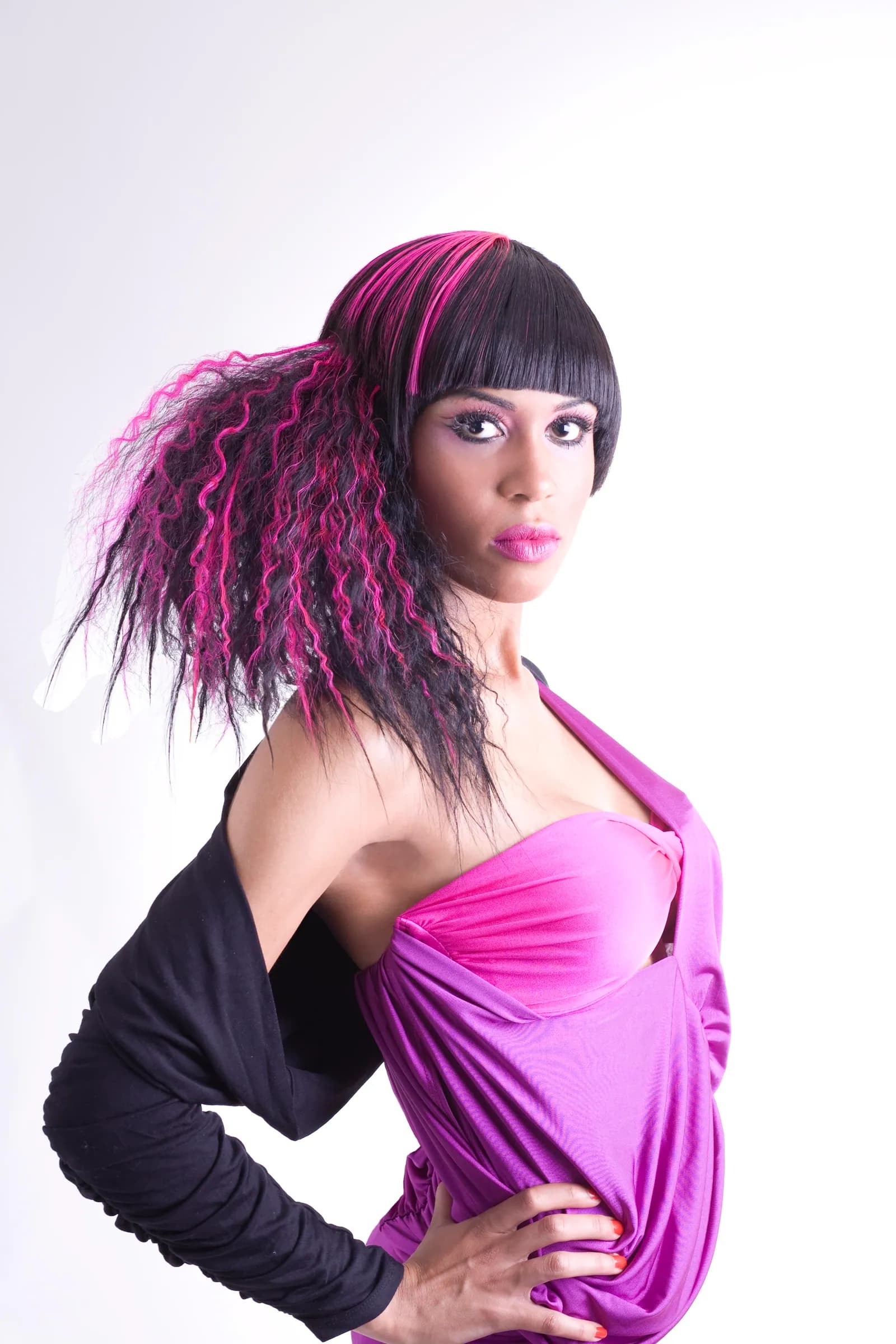 Crimped magenta lengths under a blunt black fringe, with a pink draped top